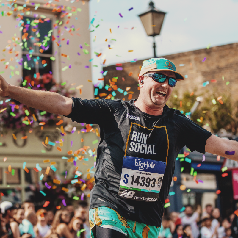 man running through colourful ribbons